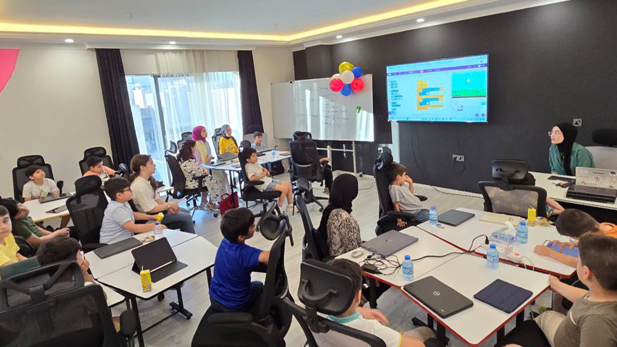 Students coding together in a classroom at The Code Lab