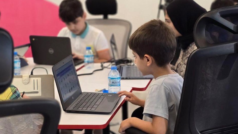 A student building a website on a laptop